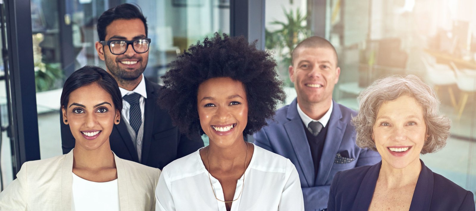 Portrait of a team of corporates standing together in an office